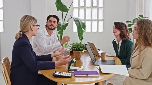 Business Team Collaborating and Discussing Strategy During Meeting