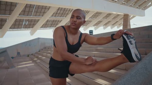 Athletic Woman Stretching Outdoors in Urban Setting