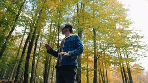 Man Uses VR Headset in Autumn Forest