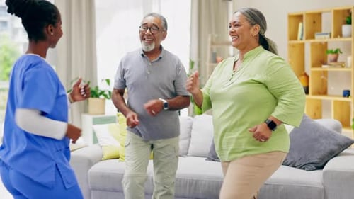 Enthusiastic Seniors Dancing with a Caregiver at Home
