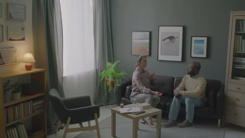 Woman Talking with Man in Therapist Office