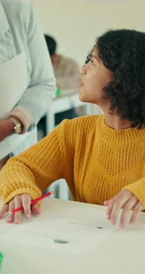 Girl Answers Question With Teacher in Classroom