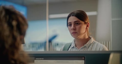 Close Up of Woman Waiting for Passport Control at Airport Checkin Counter