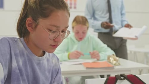 Teens Studying in Classroom with Teacher