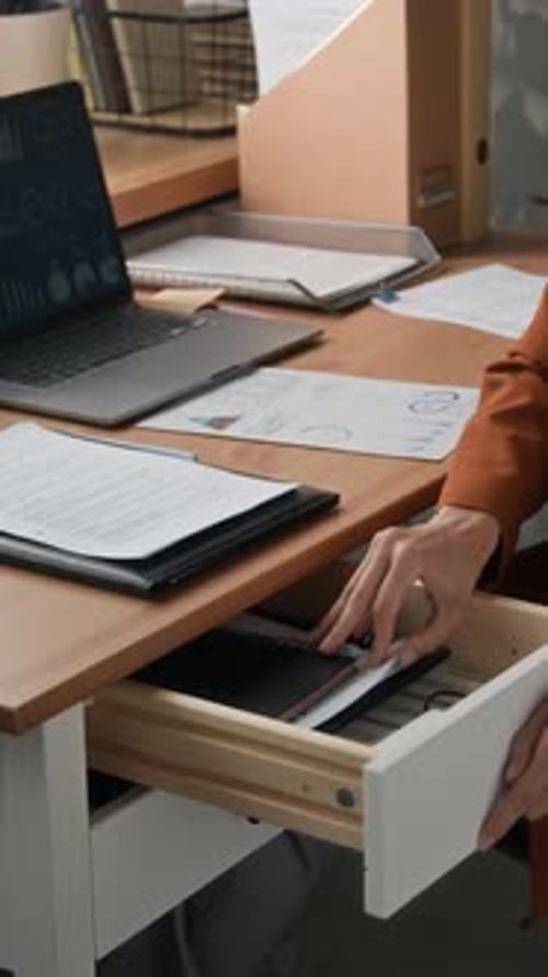 Office Employee Taking Highlighter from Drawer While Doing Paperwork