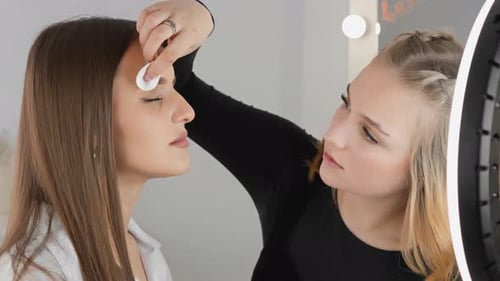 Makeup Artist Applying Makeup on Beautiful Woman