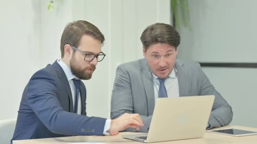 Team Celebrate Business Success with Laptop in Office
