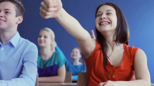 Education, Gesture, People And Learning Concept - Students Showing Thumbs Up On Lesson At School