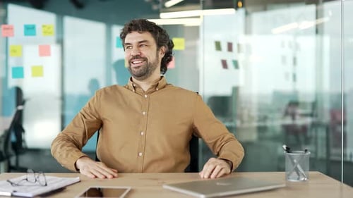 Happy Man Relaxing After Finishing Work on Laptop