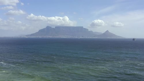 4k video footage of the ocean with a mountain in the background in Cape Town, South Africa