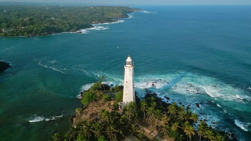 Aerial View Vintage Dutch Lighthouse on Tropical Island Surrounded By Greenery Azure Ocean Waters