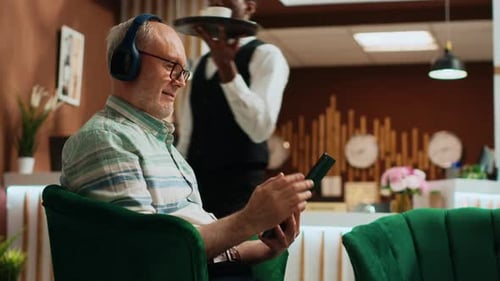 Senior Man Using Tablet in Hotel Lobby