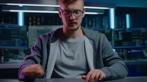 Man Typing at Computer in a Futuristic Office
