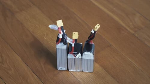 Three lithium-polymer batteries standing with connectors in the sky