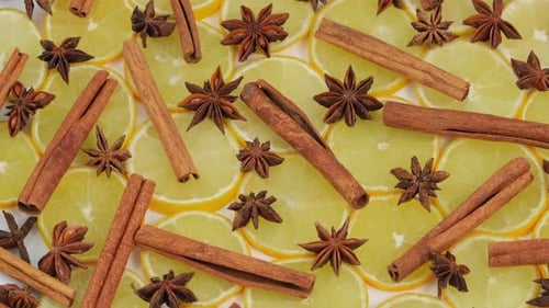 Lemon slices, star anise, cinnamon close-up, food background