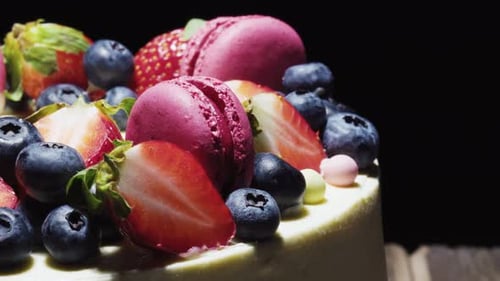 Delicious Cake Topped with Berries and Macarons
