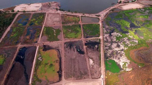 Silt Fields Separated By Ground Mounds on Riverbank