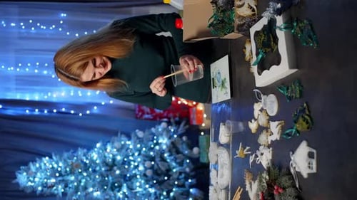 A Woman Makes Christmas Tree Decorations From Epoxy Clay in a Craft Workshop