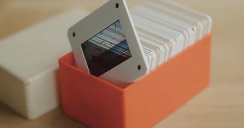orange slide case on wooden table, slow motion rotation