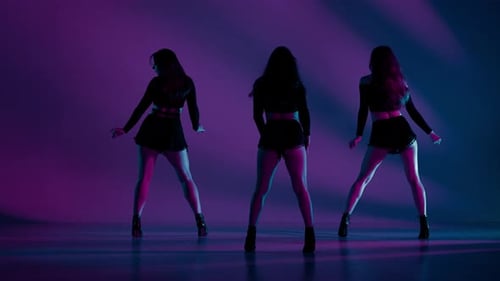 Group of Three Women Dancing Heels Dance in a Studio Pink and Blue Neon Lights Striped Shadowed