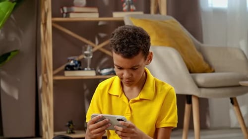 Child Using Phone for Games in Home Setting
