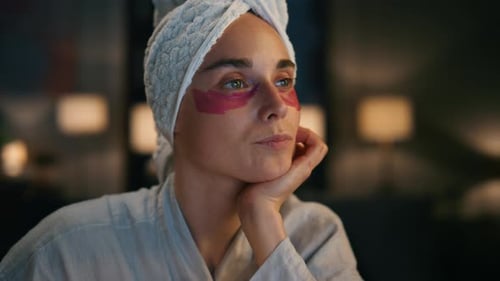 Woman with towel and eye mask relaxing at home