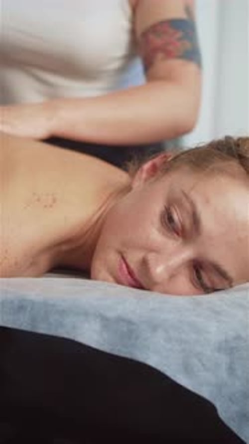 Woman Receives Back Massage at Day Spa
