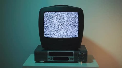 Television Showing Static Sits Atop VCR