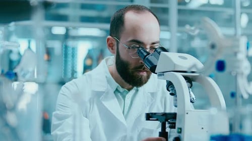 Scientist Using Microscope in Laboratory, Close Up