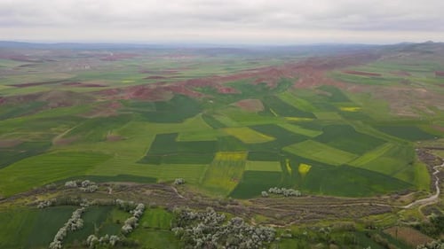 Farmlands And Red Mountains