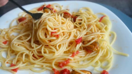 Person Twirling Seafood Spaghetti with a Fork