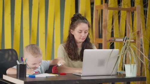 Little Kid Drawing When His Mother Working