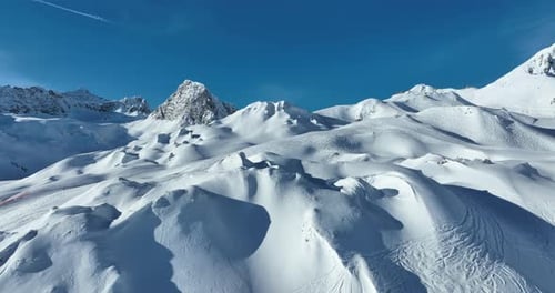 Aerial View of Snowy Mountains on a Sunny Day