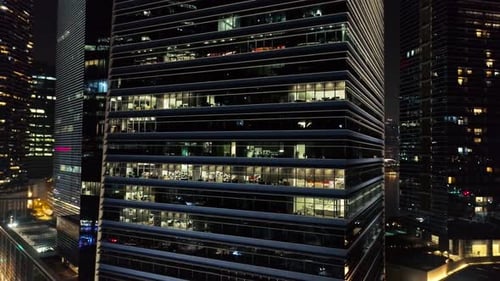 Modern Office Building at Night with Interior Lights on