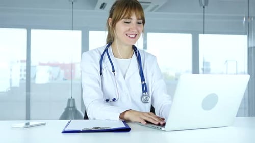Young Woman Doctor Using Laptop for Telemedicine Call