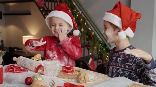 Children Making Christmas Cookies in Decorated Kitchen