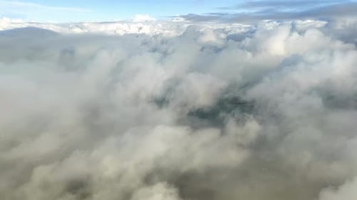 Airplane Descending Toward Clouds and Ground Below