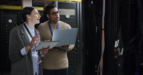 Team, problem solving and data center, woman and man with tablet, laptop