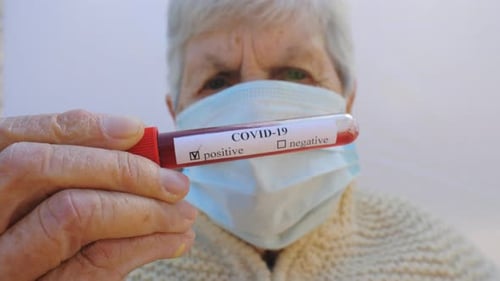 Old Lady with Protective Mask Holding Her Blood Test with Positive Result on Coronavirus Sick Granny