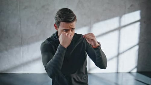 Powerful Kickboxer Fighting Shadow in Building Closeup Fighter Practicing Kicks