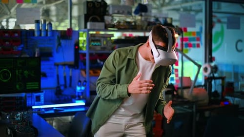 Portrait of a young man in VR glasses dancing like a robot