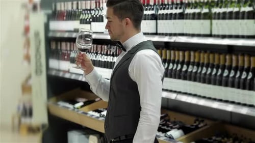 Young Adult Man Smelling Wine in a Shop