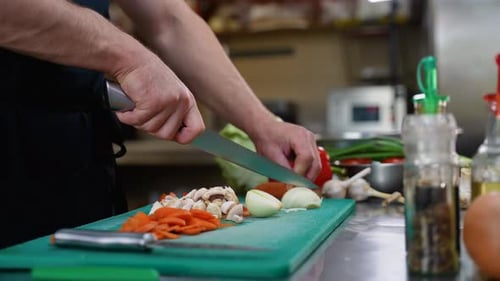 Chef Cutting Vegetables in the Hotel Kitchen Close Up