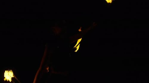Woman Performing Fire Dance at Night