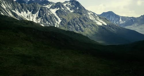 Majestic Mountain Landscape Showcasing Snow Capped Peaks and Lush Valleys