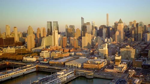 Witness a Stunning Aerial View of a Vibrant City Skyline Bathed in the Glow of Sunset