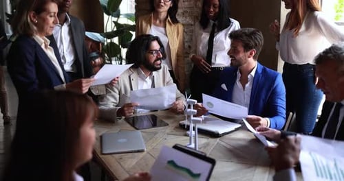 Happy business people celebrating renewable energy project success at office