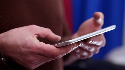 Hands Using Silver Tablet Device Indoors