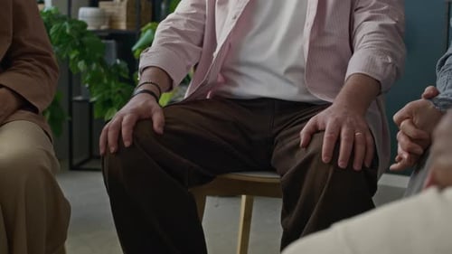 People sitting in circle at indoor meeting