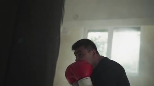 Fighter Exercises with Punching Bag Blocking Face